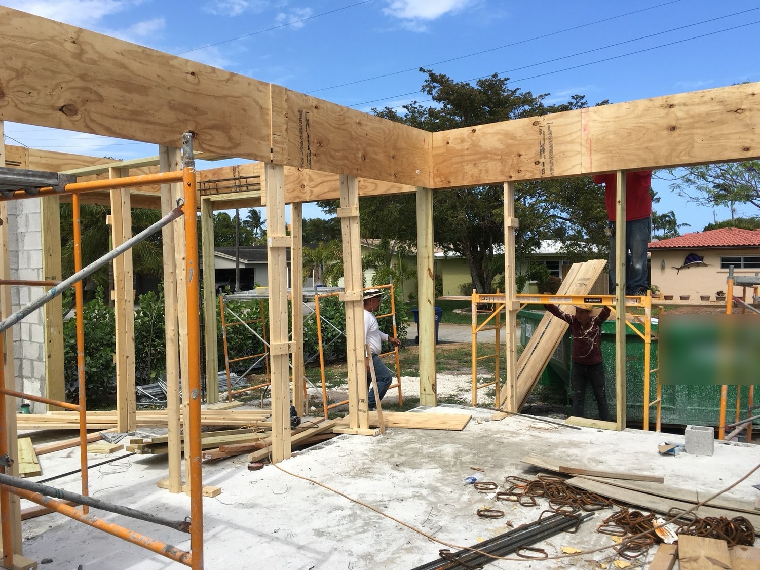 Plywood tie beam formwork carried on shored timber posts, with reinforcing steel staged on the slab