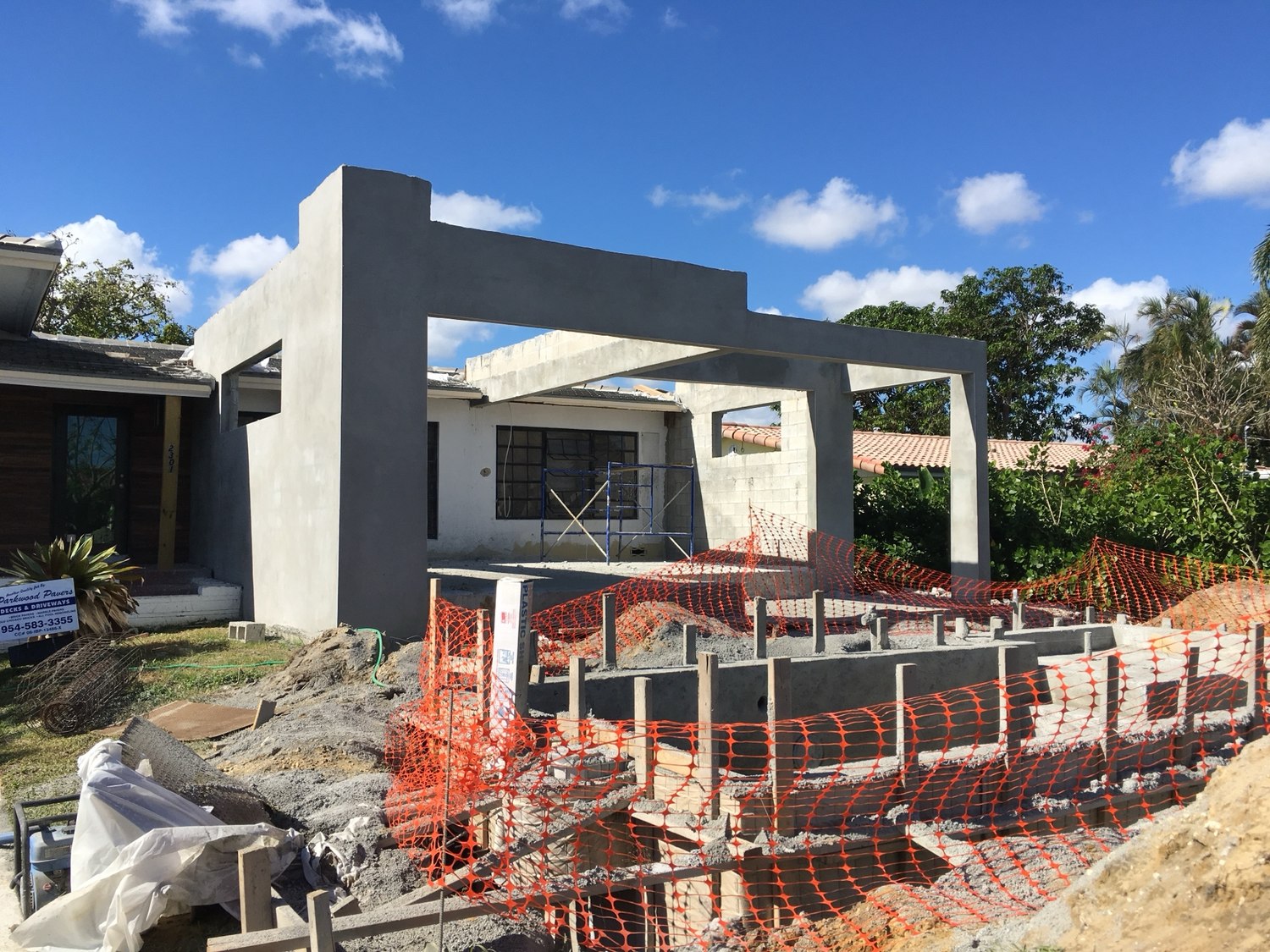 Formwork and safety fencing around the pool alongside the new addition