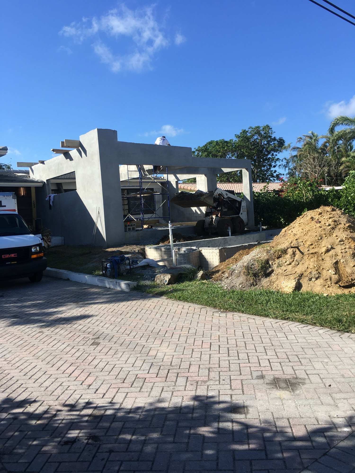 The new addition seen from the street with the paver driveway and sitework under way