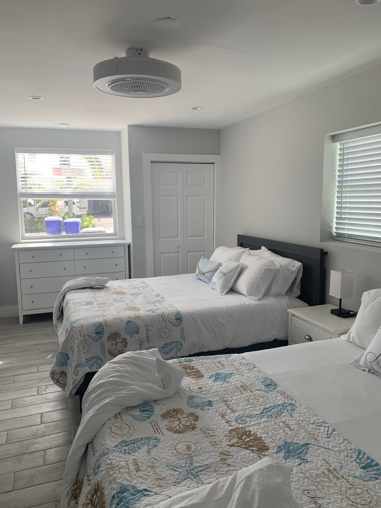 Finished guest bedroom with two beds, new window and trim complete