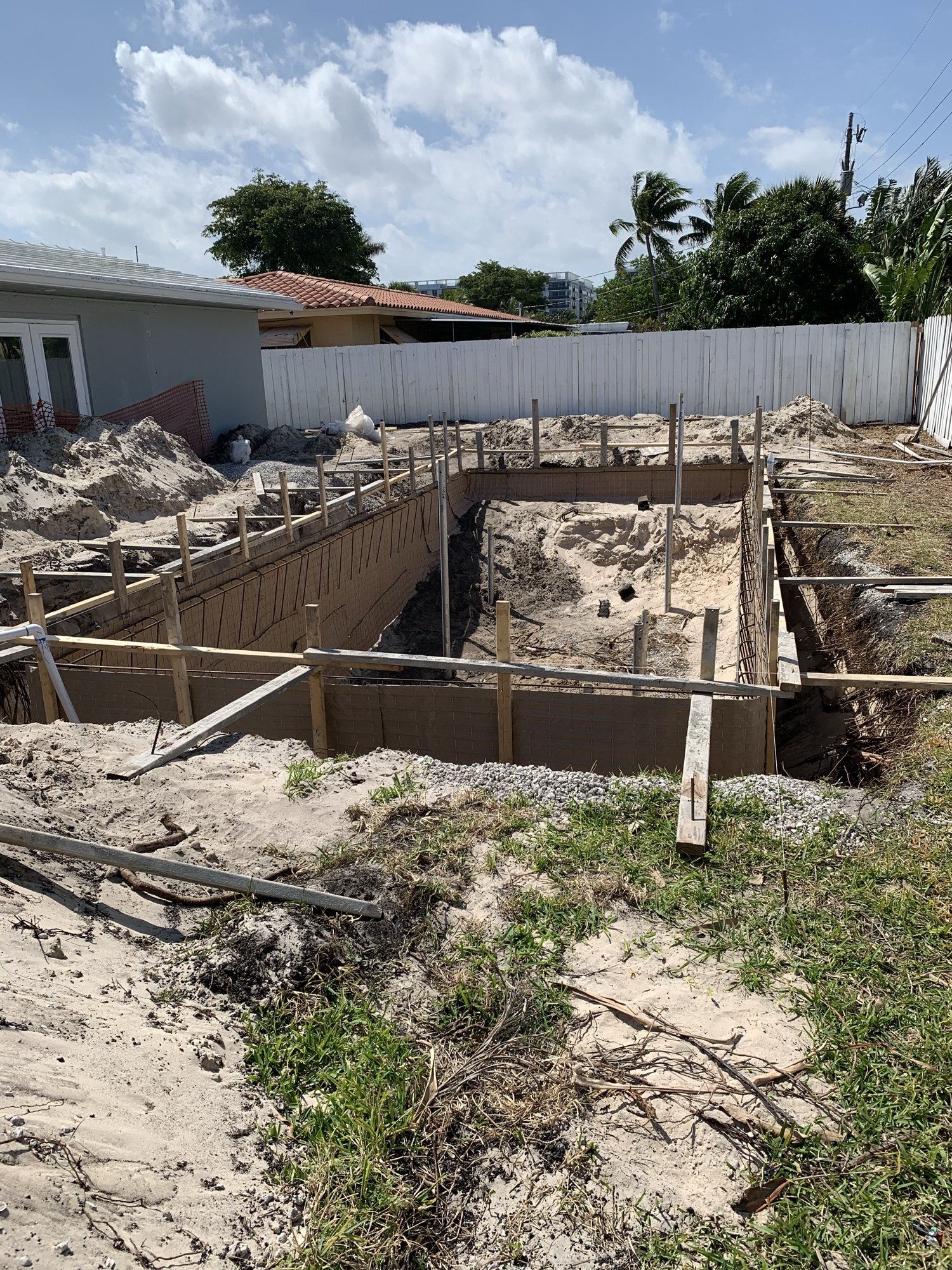 Excavation for a new swimming pool with formed footings and shoring
