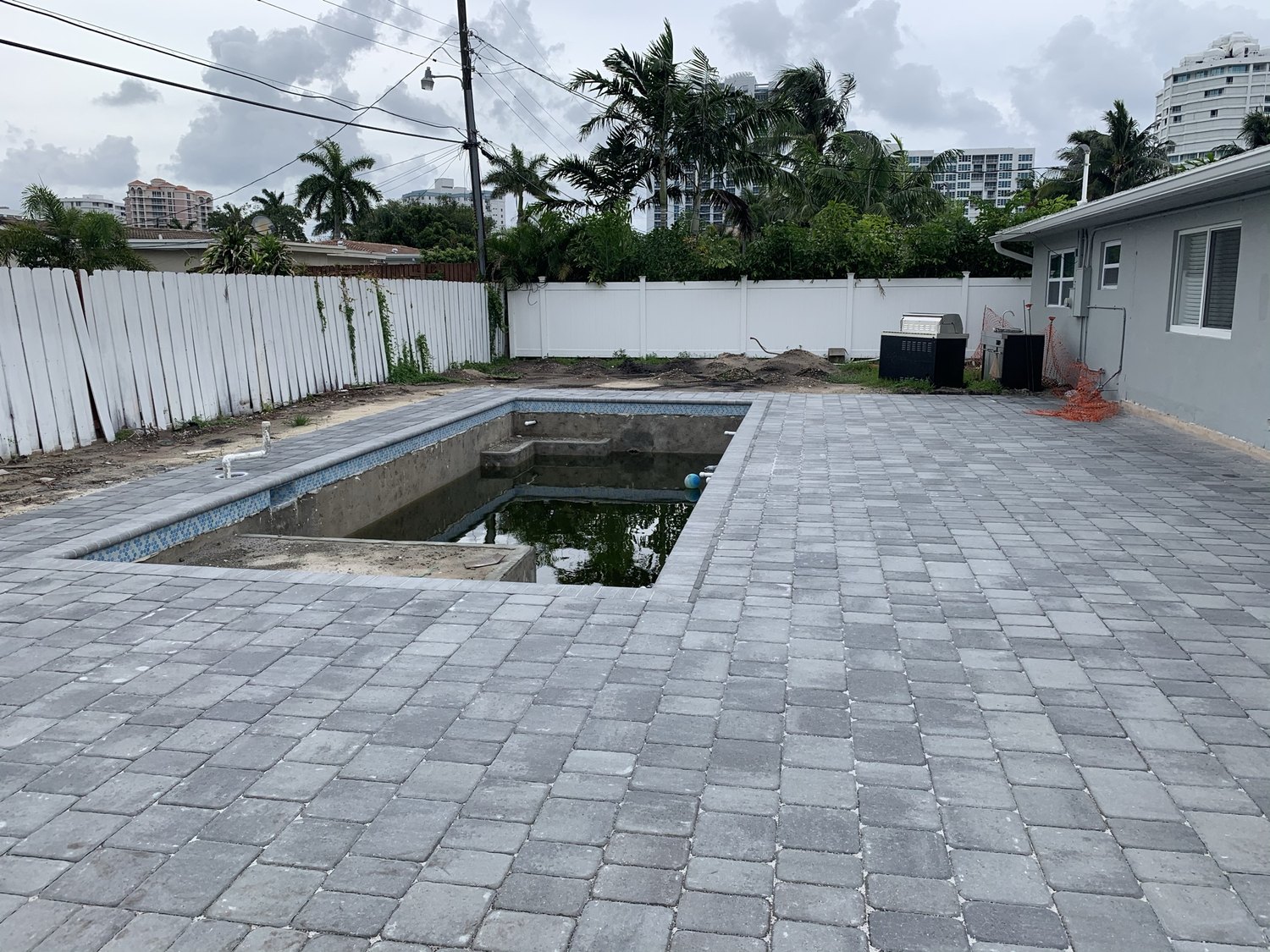 Paver deck set around the finished pool shell before the pool was filled