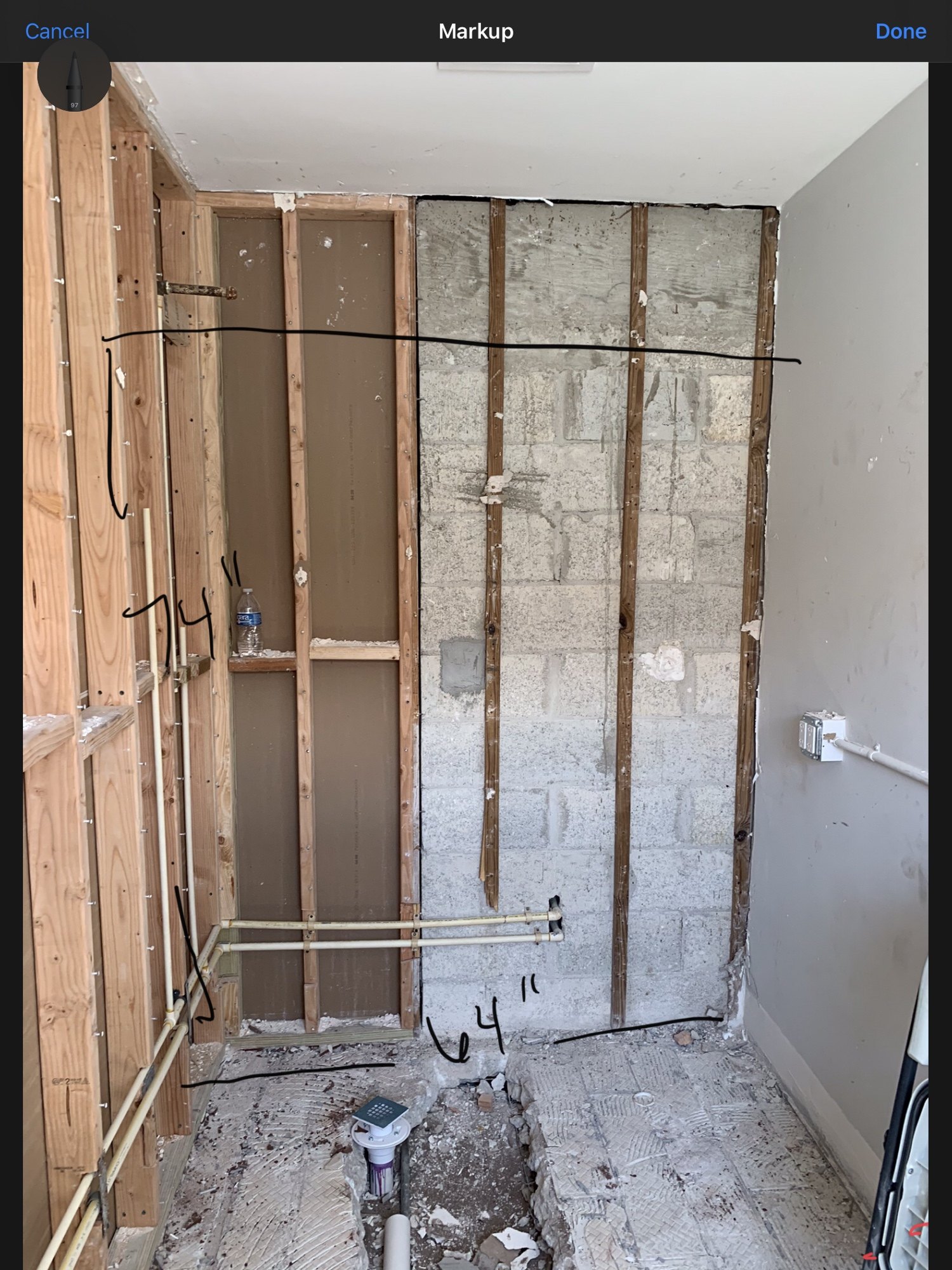 New copper supply and drain lines run against concrete block for a new bathroom