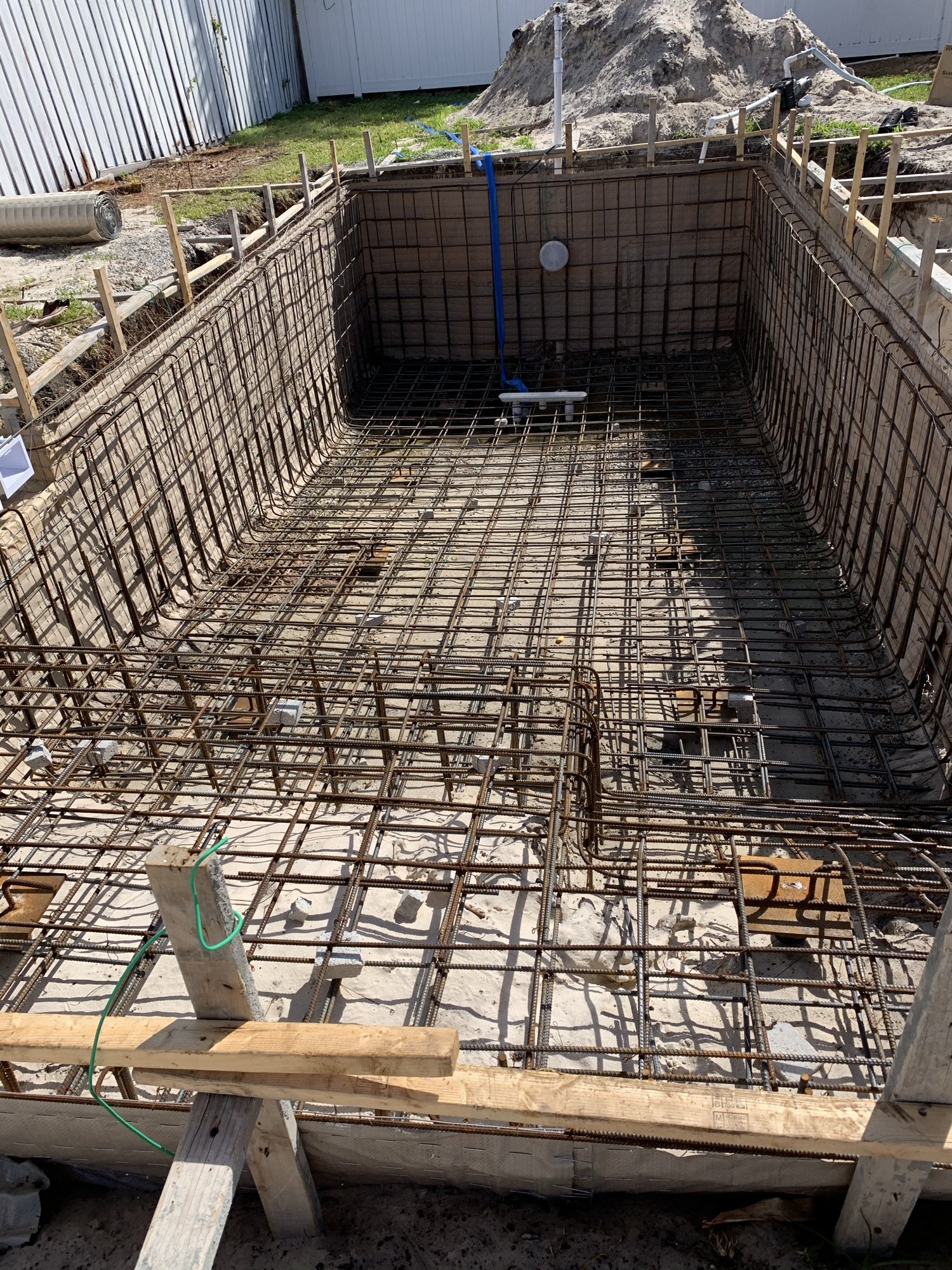 Reinforcing steel cage tied in the pool shell before shotcrete