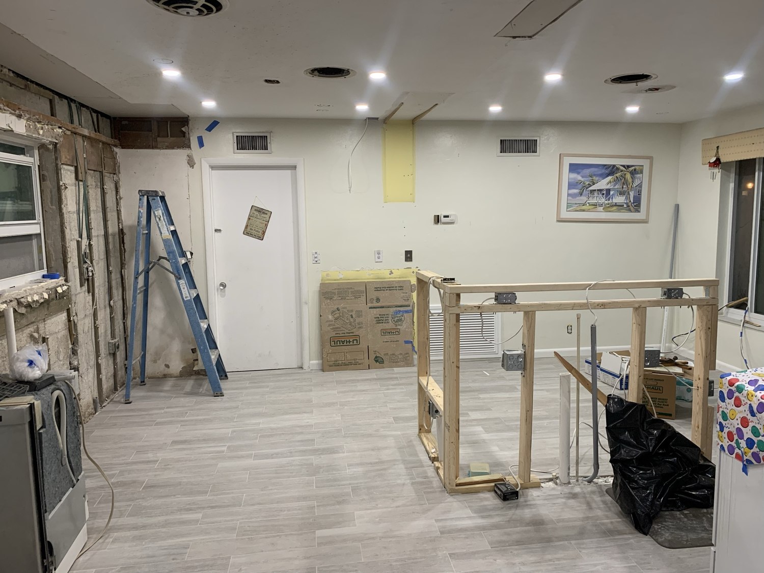 New framing, recessed lighting and new flooring in the opened-up kitchen