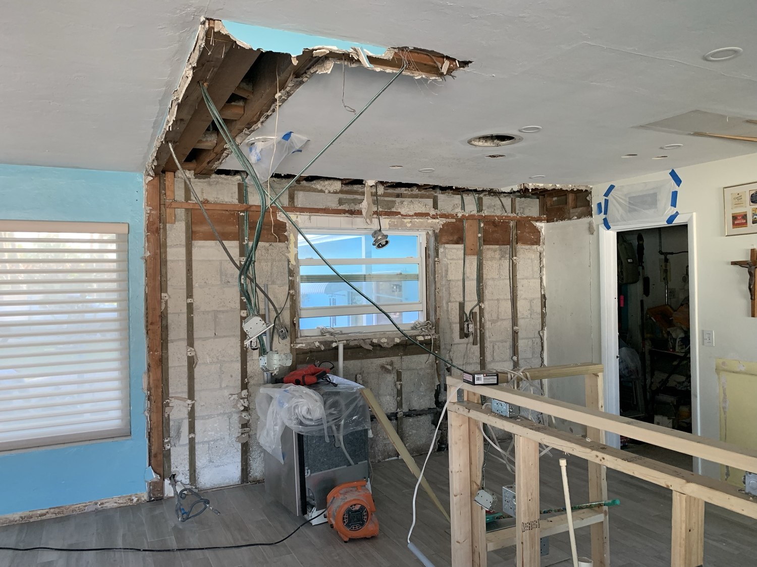 Load-bearing wall opened between the kitchen and living room with a temporary support wall in place