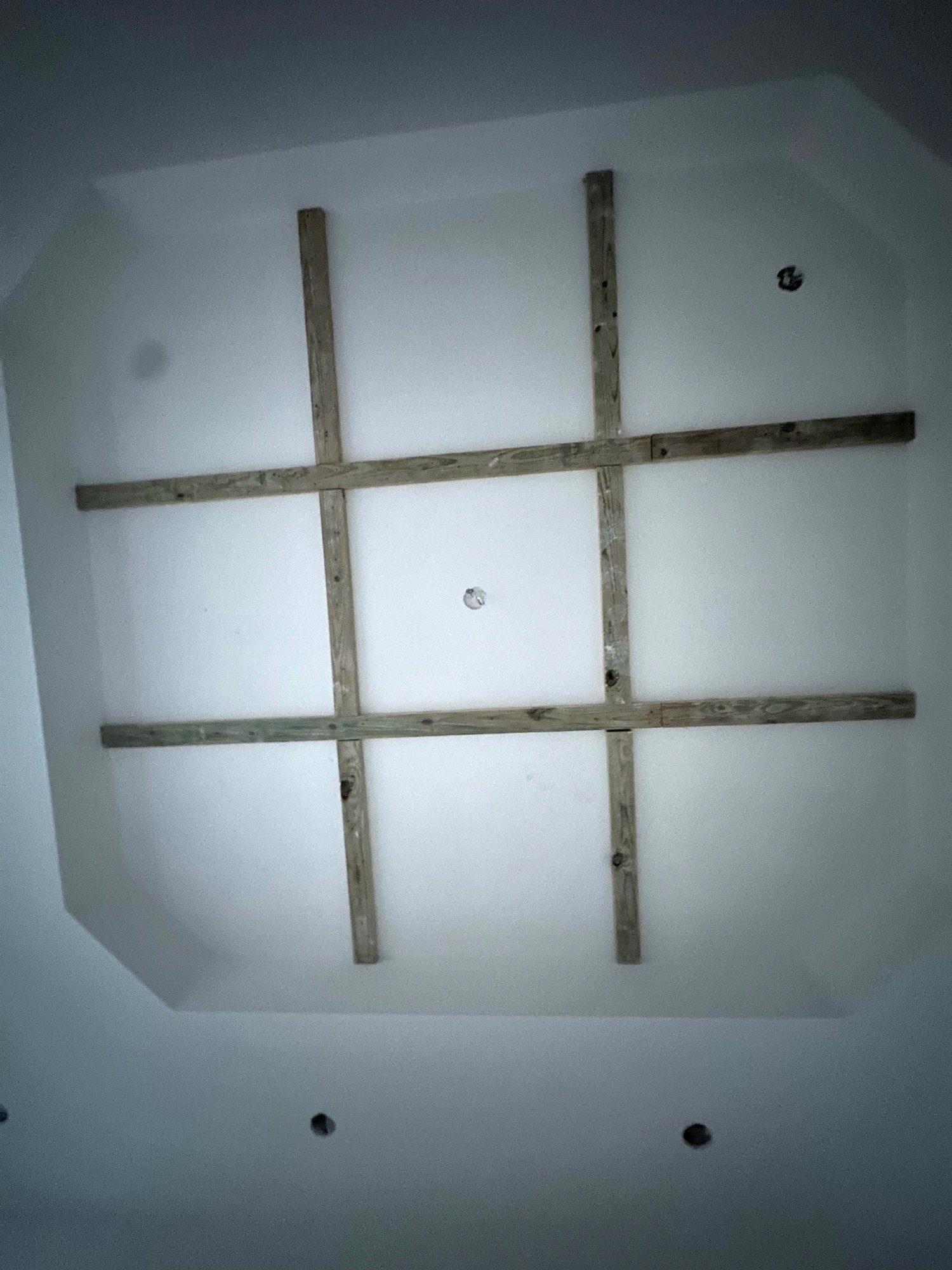 Pressure-treated wood grid framed into a recessed ceiling to lay out a coffered ceiling