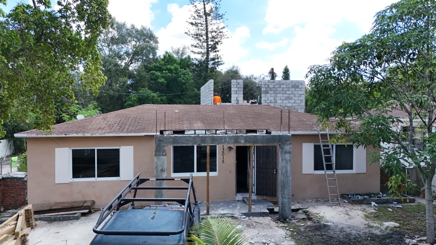 Aerial front view with the block walls at full height and the original roof still in place