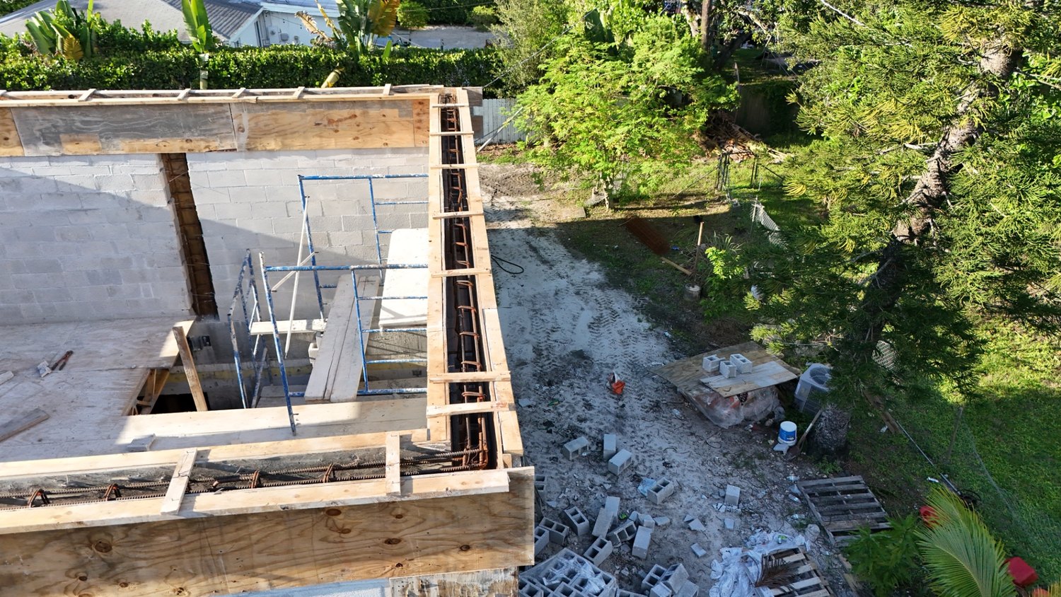 Concrete tie beam formed and braced along the top of the block walls